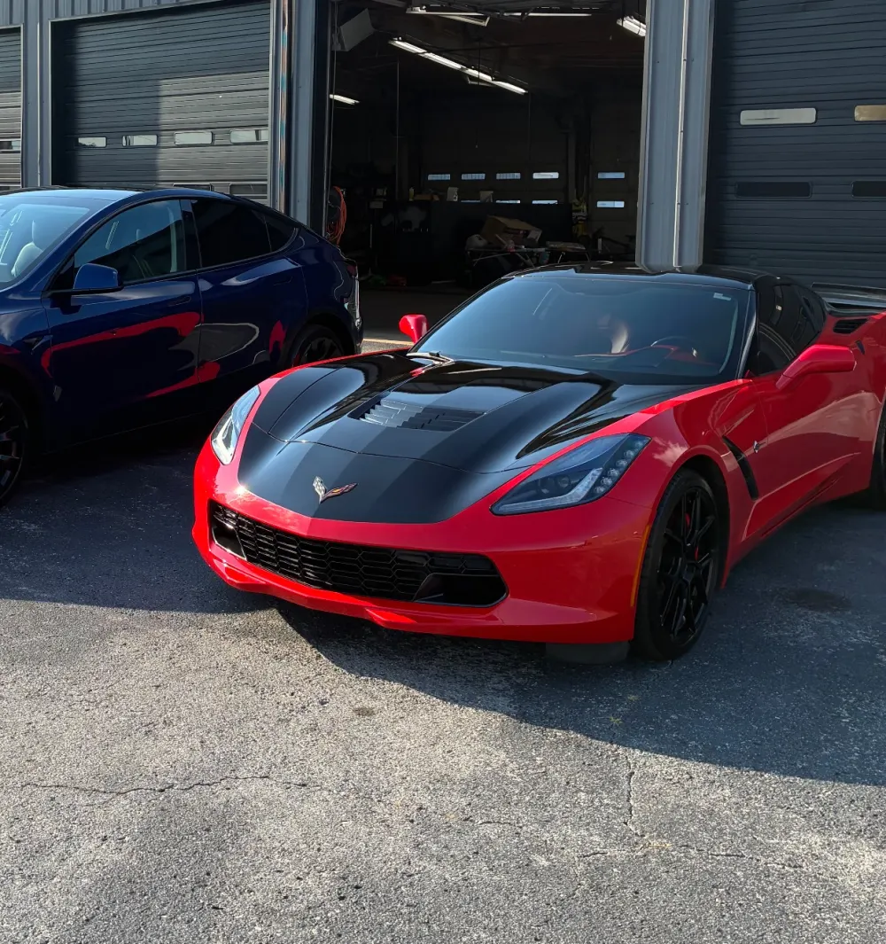 Red and black Corvette Stingray with a mirror-gloss finish after detailing